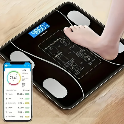 Digital body fat scale with a smartphone app displaying health metrics on a wooden floor.