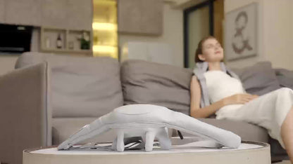 Woman sitting on a couch with a device on a table in front of her
