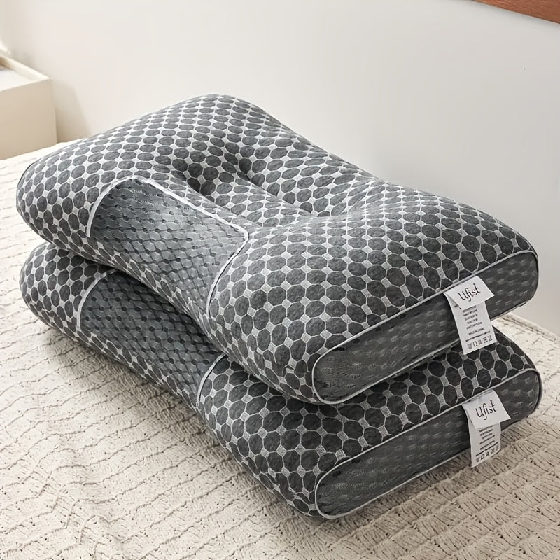 Two gray patterned pillows stacked on a white surface with 'Ufset' labels.