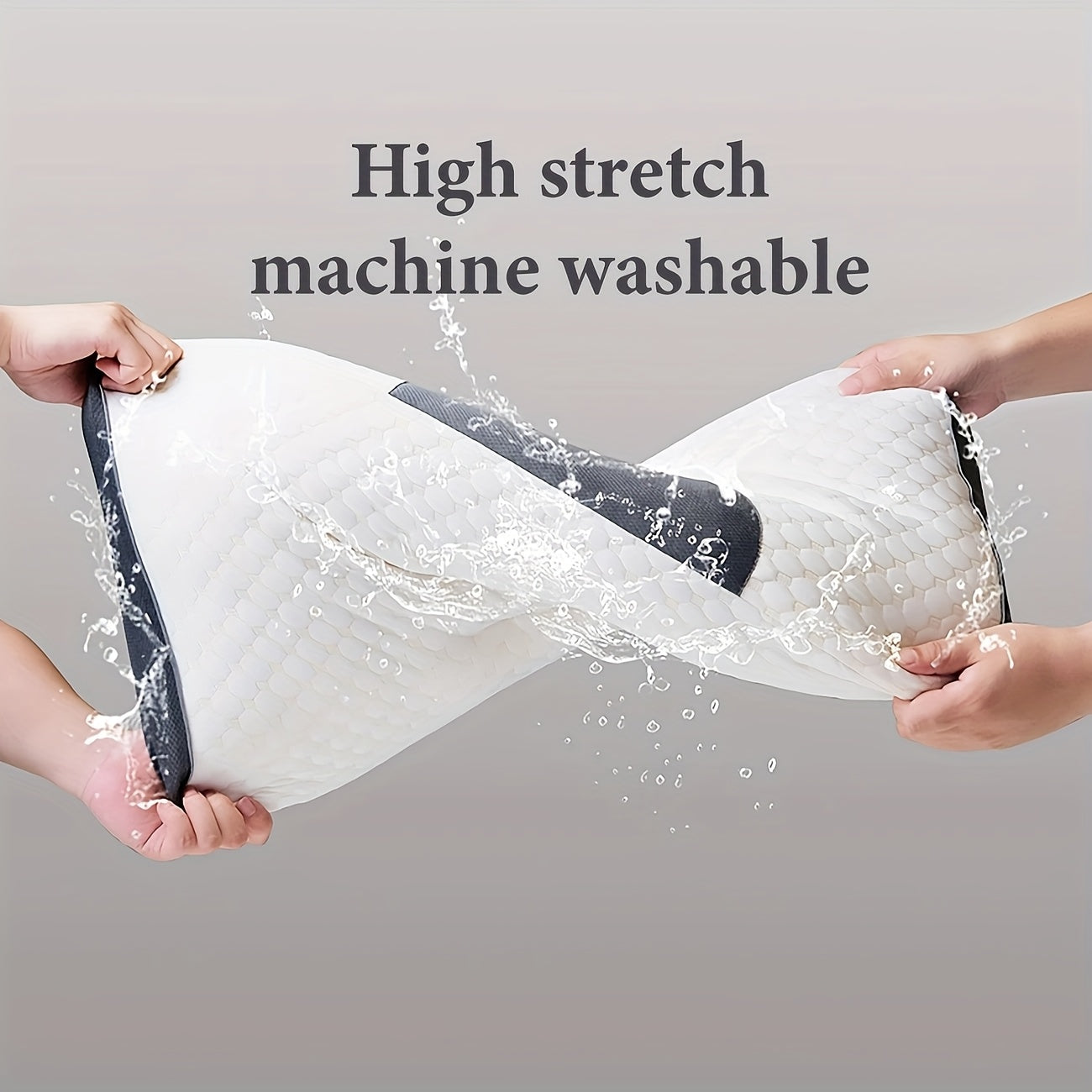 Two hands stretching a high stretch, machine washable product with water splashes on a gray background.