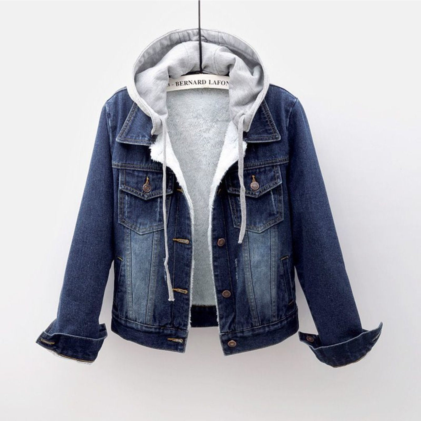Denim jacket with gray hoodie on a white background