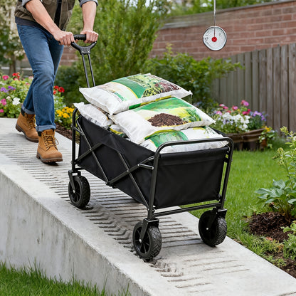 Person pushing a black folding cart with gardening supplies on a garden path.