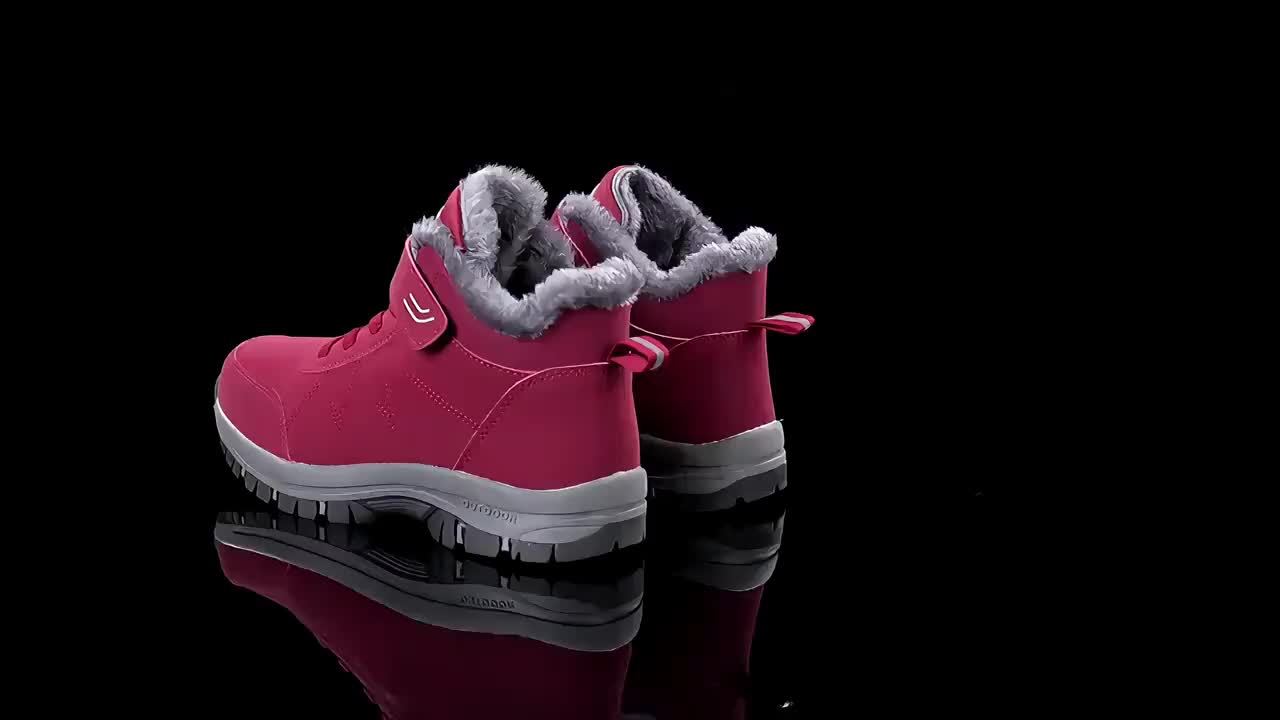 Pink winter boots with gray fur lining on a black background