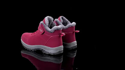 Pink winter boots with gray fur lining on a black background